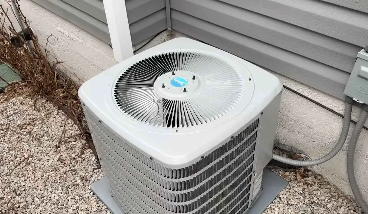 Technician inspecting noisy AC unit
