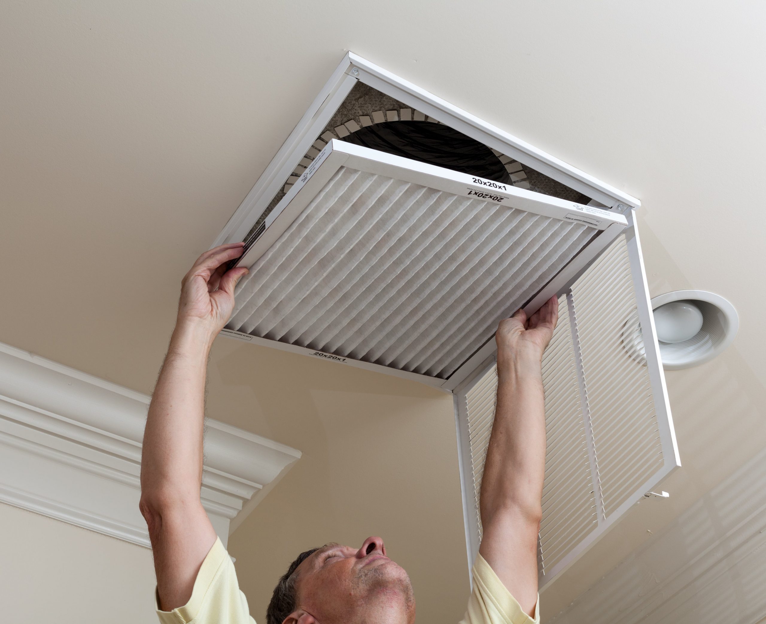 Homeowner replacing HVAC air filter